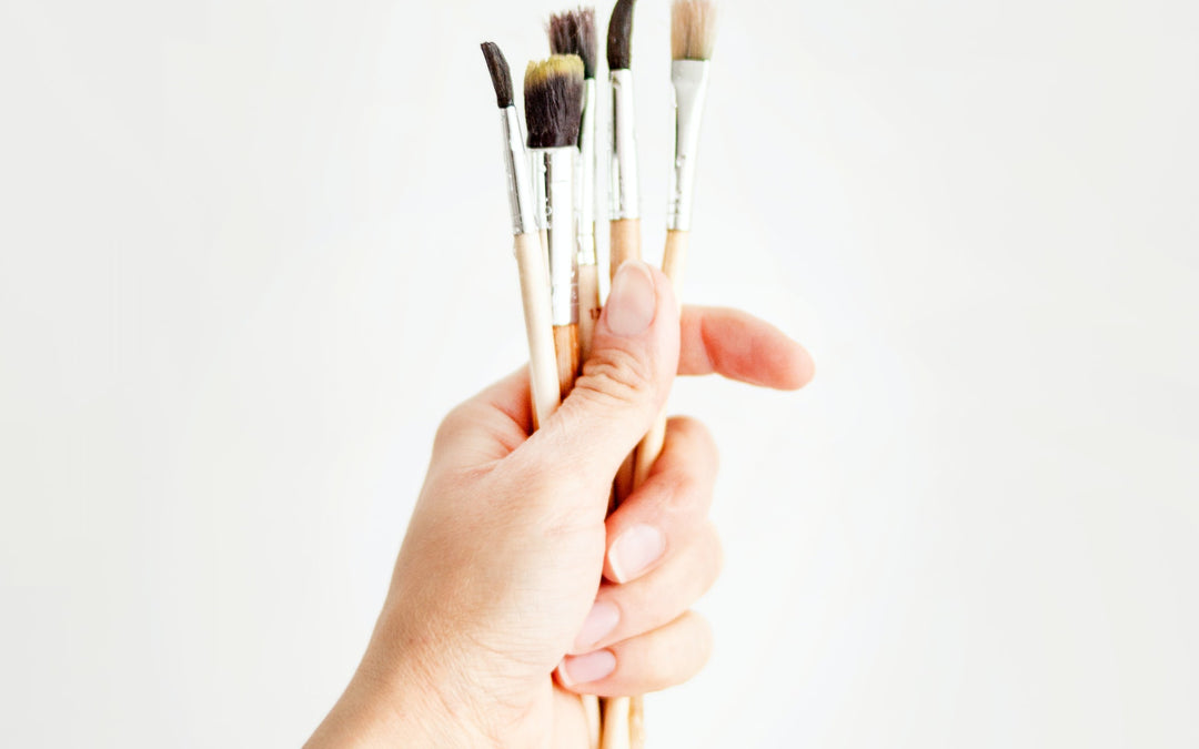 holding paint brushes