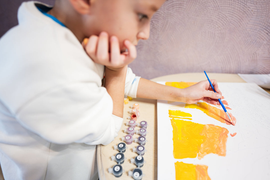 Boy painting by numbers