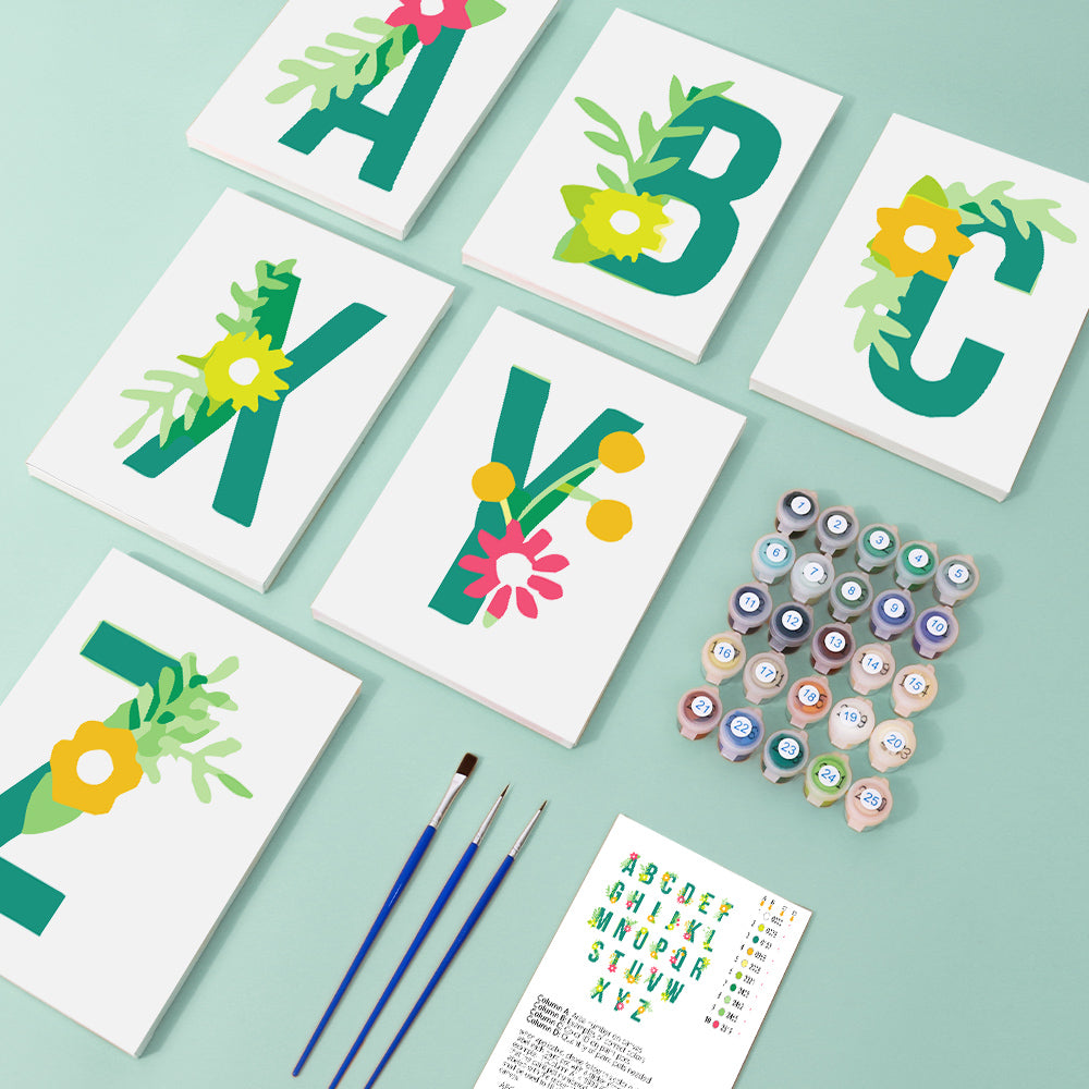 Alphabet cards with floral designs on a light green background, accompanied by paint cans and brushes.