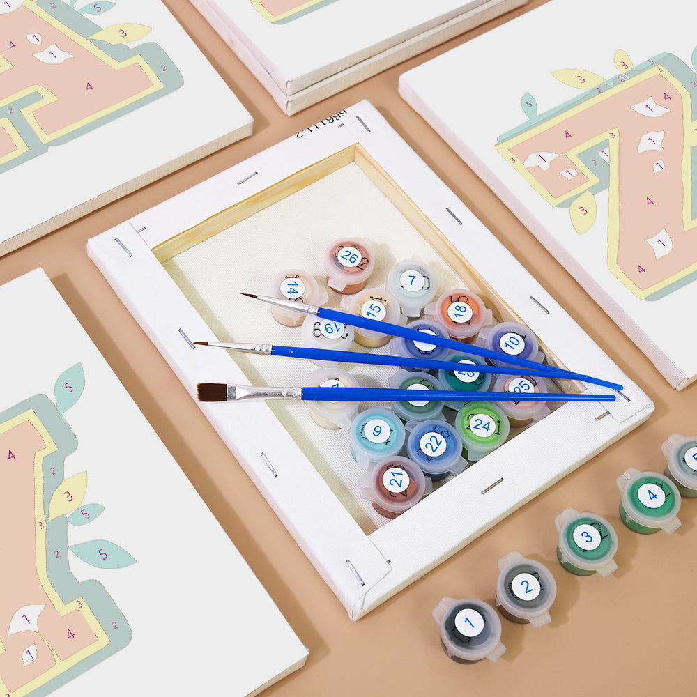 Artistic setup with paint tubes and brushes on a wooden surface