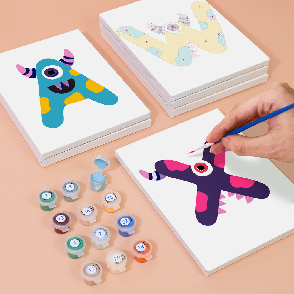 Colorful monster cards with stamps on a beige surface