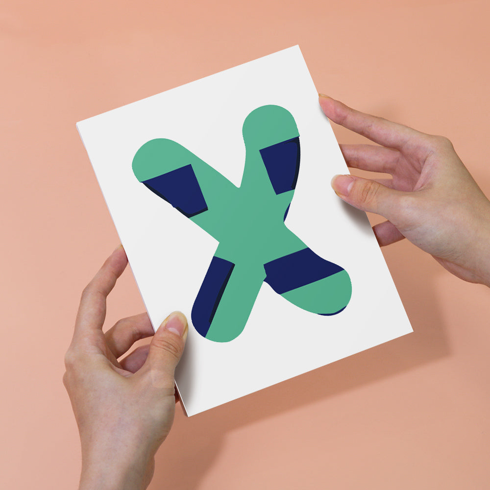 Hands holding a card with a green and blue abstract design on a peach background