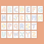 Pastel-colored alphabet letters on a peach background