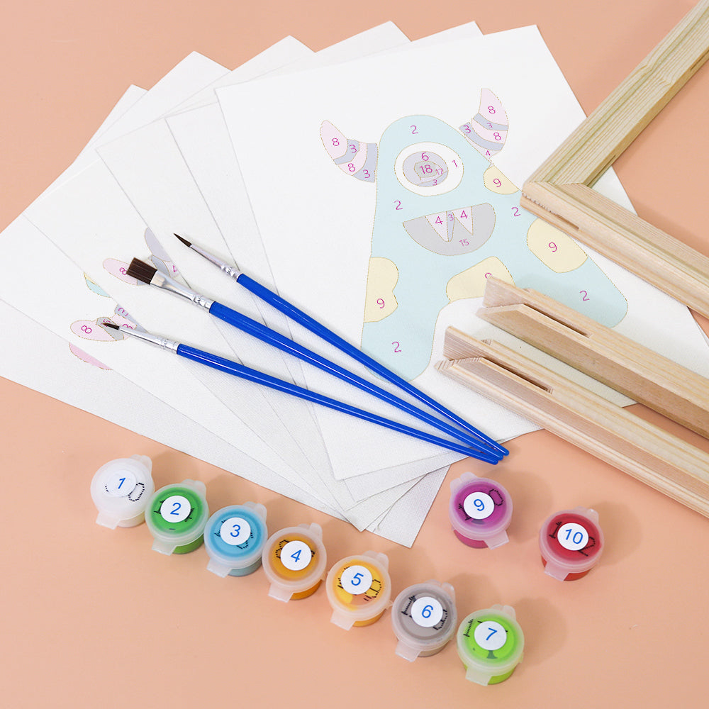 Art supplies including paintbrushes, color swatches, and a small easel on a peach background