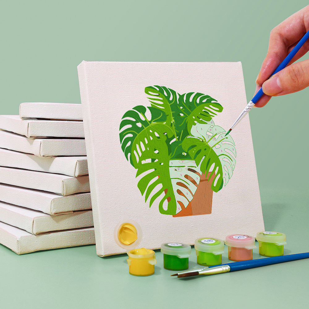 Close-up of paint by numbers kit with small pots of vibrant paint