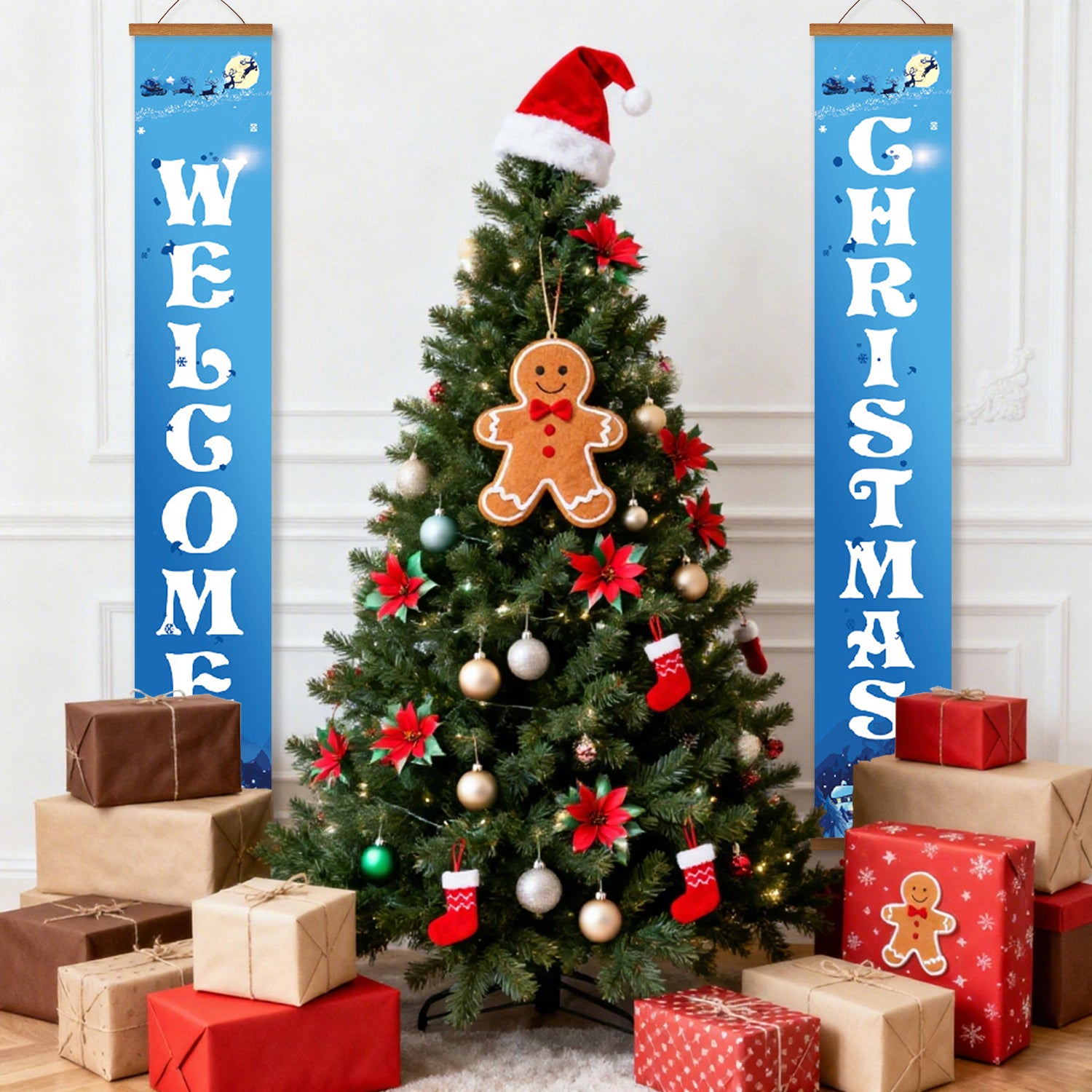 Decorated Christmas tree with gingerbread ornaments, surrounded by wrapped presents, against a white wall.