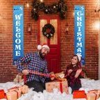 Two people in festive attire sitting on a snowy floor with Christmas decorations and gift boxes.