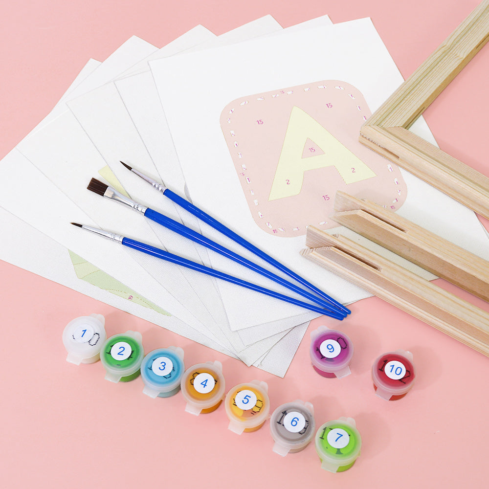Art supplies including paintbrushes, paint containers, and paper on a pink background