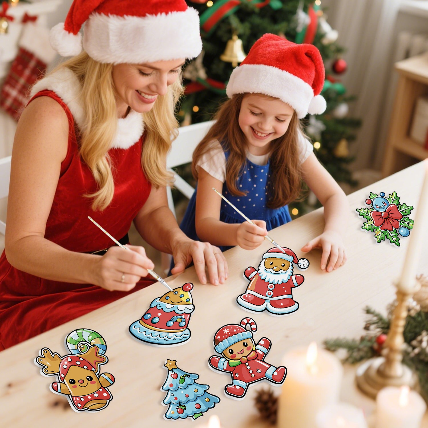 Mujer y niño con gorros de Papá Noel pintando adornos navideños en una mesa con un árbol decorado al fondo.