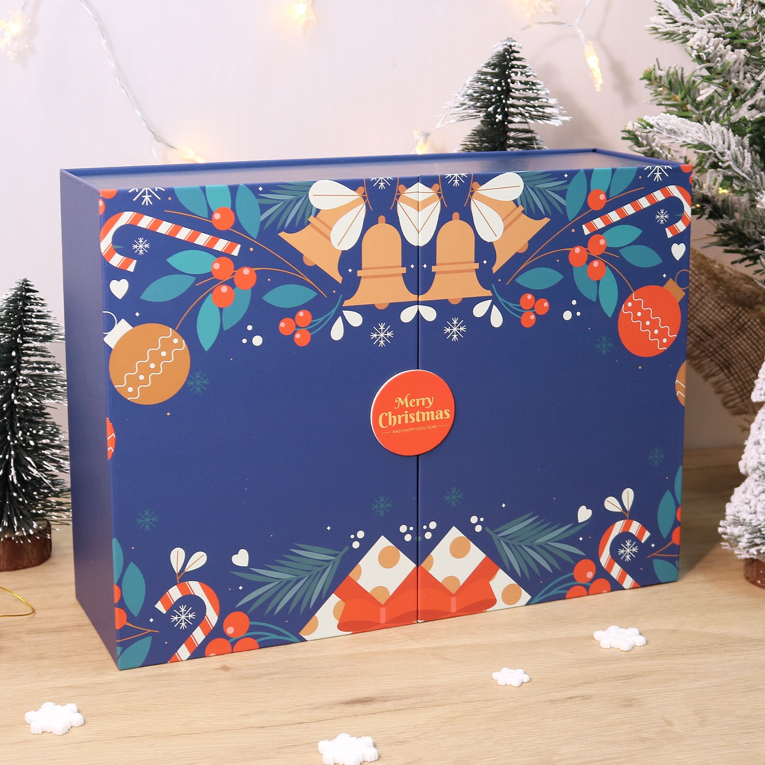 Decorative Christmas box with festive patterns on a wooden surface.
