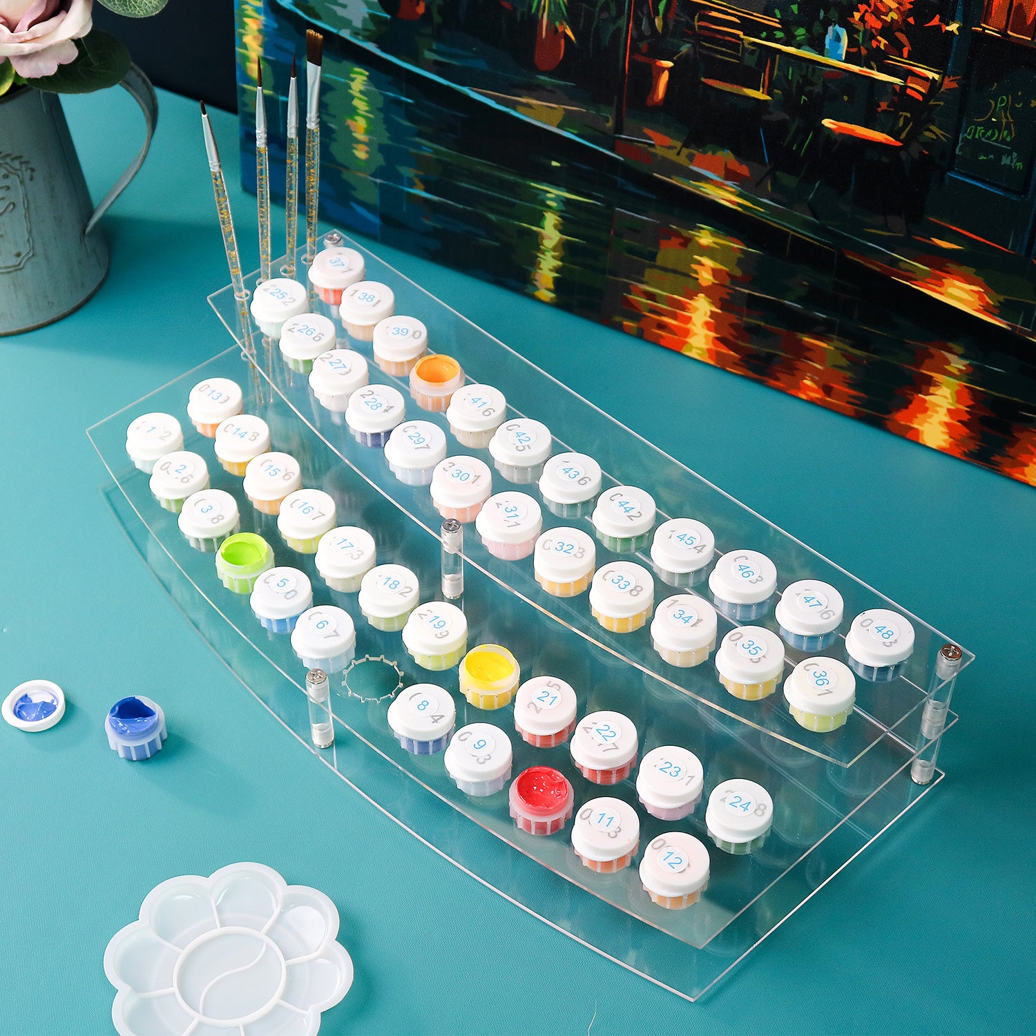 Set of small containers with lids on a clear stand against a colorful background