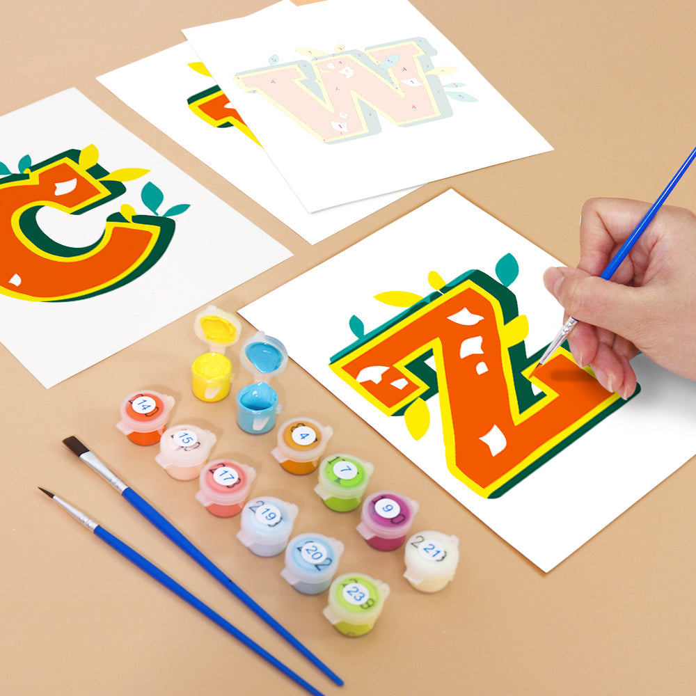 Coloring activity with letters 'C' and 'Z' on paper, surrounded by paint containers and brushes.