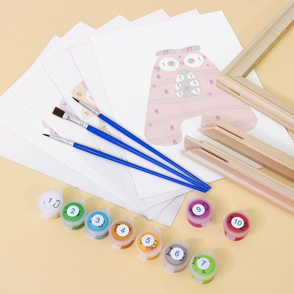 Art supplies including paintbrushes, paint containers, and a pink owl painting on a beige background.