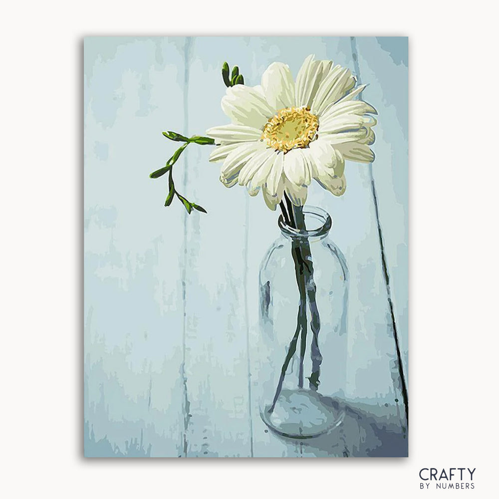 A paint-by-numbers kit image featuring a single flower in a clear vase against a blue background, labeled 'CRAFTY by Numbers'.