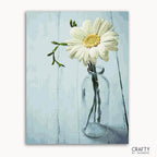 A paint-by-numbers kit image featuring a single flower in a clear vase against a blue background, labeled 'CRAFTY by Numbers'.