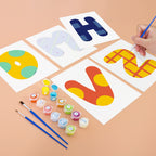 Children's painting activity with letters 'H', 'N', and 'V' on paper, surrounded by paint containers and brushes.