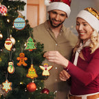 Man and woman wearing Santa hats in front of a Christmas tree with decorative ornaments.