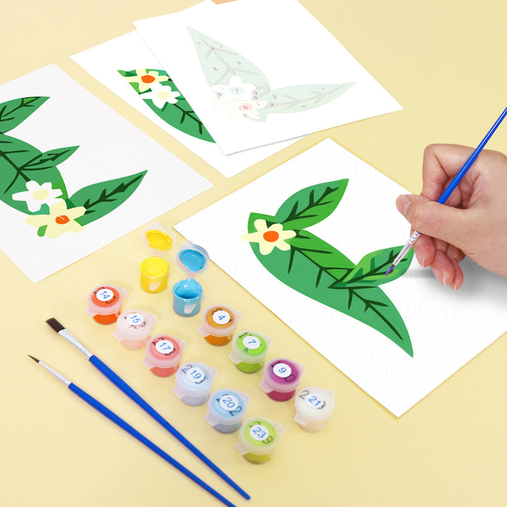 Children painting leaves on paper with paint and brushes on a yellow surface