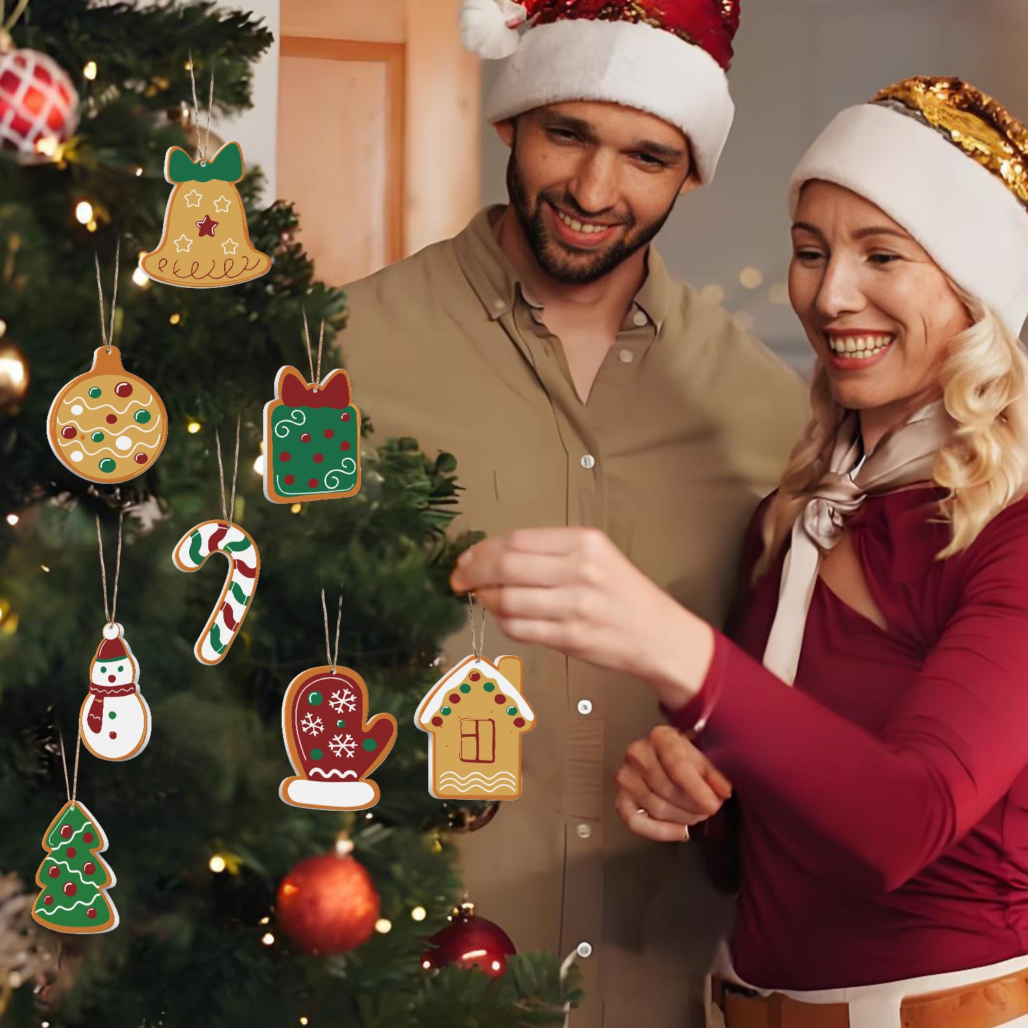 Man and woman in festive hats standing next to a Christmas tree with decorated ornaments.