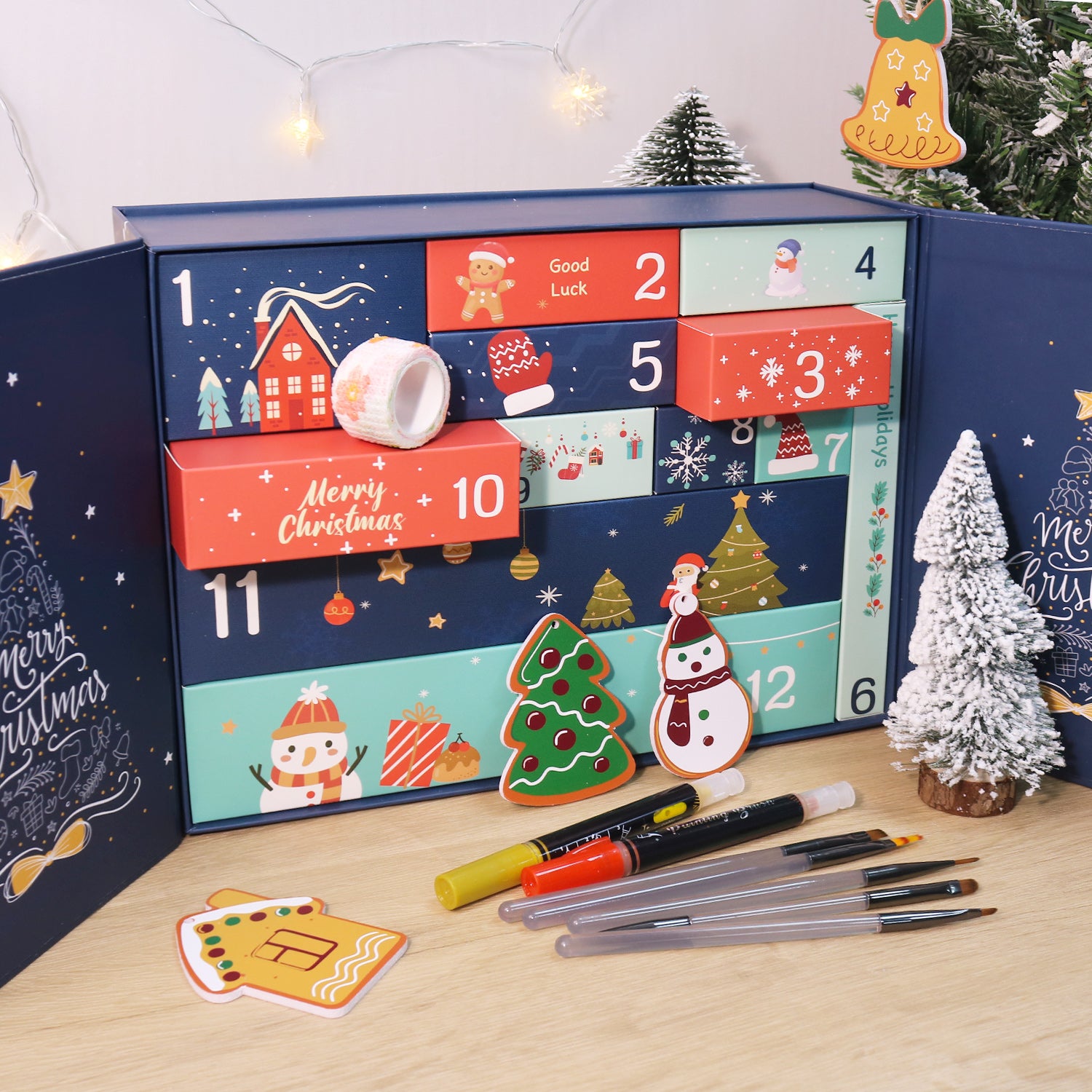 Advent calendar with Christmas-themed designs and markers on a wooden surface.