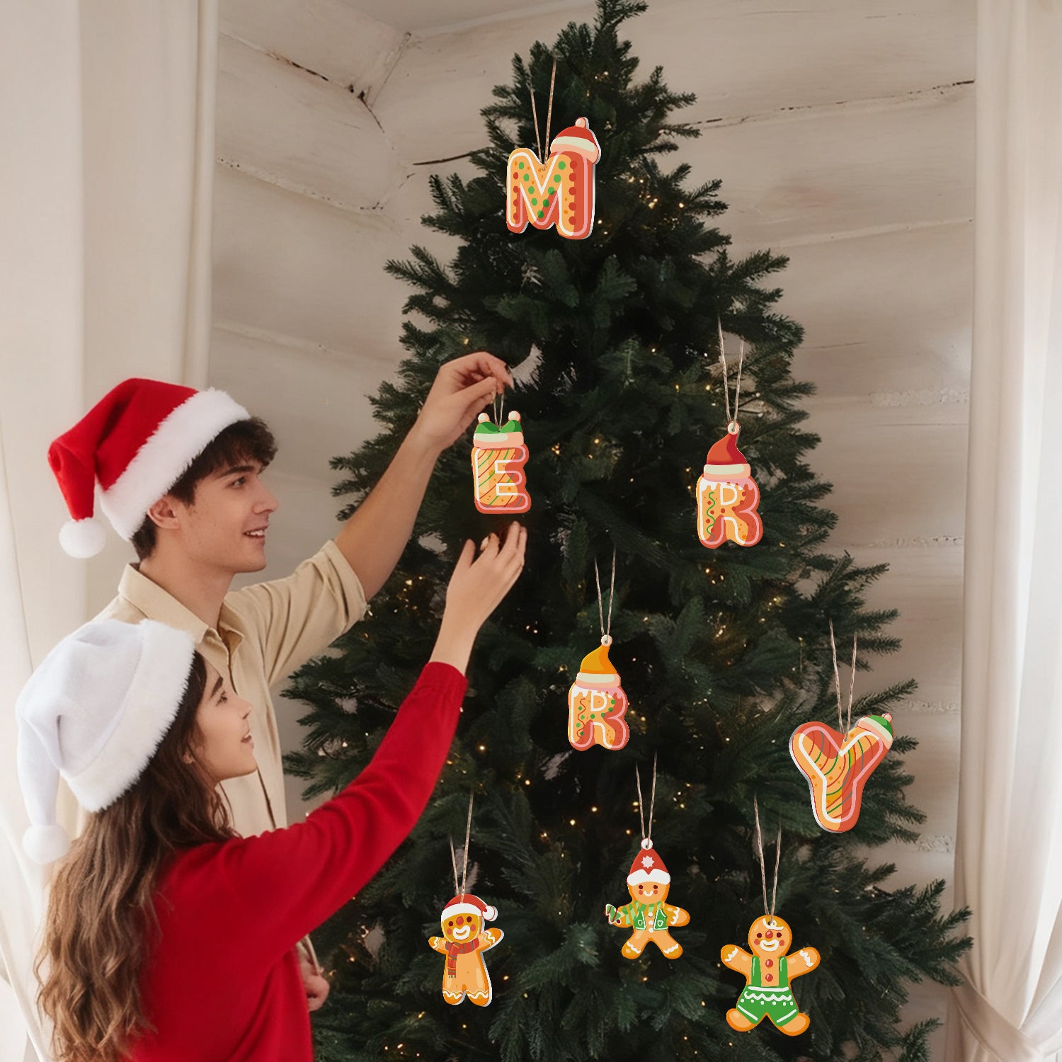 Two people decorating a Christmas tree with gingerbread-themed ornaments.