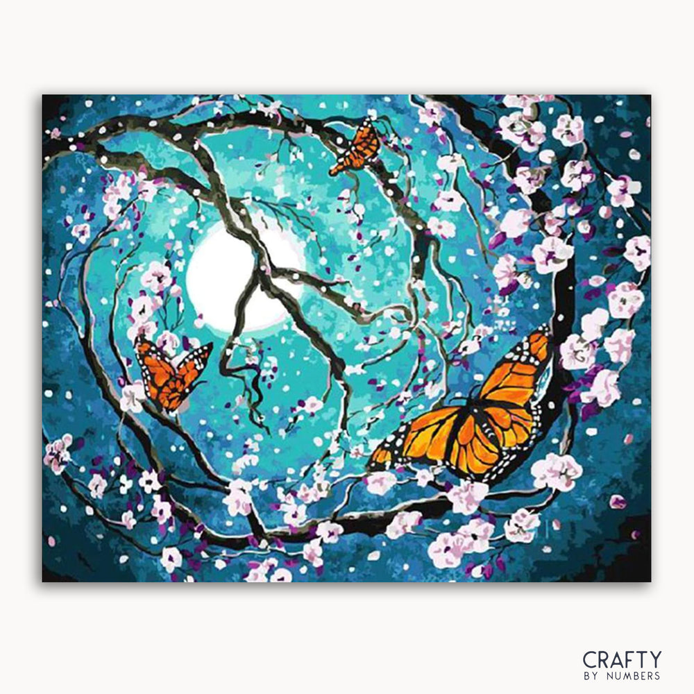 A vibrant painting featuring a floral and butterfly motif with a blue background, numbered canvas for paint-by-numbers.