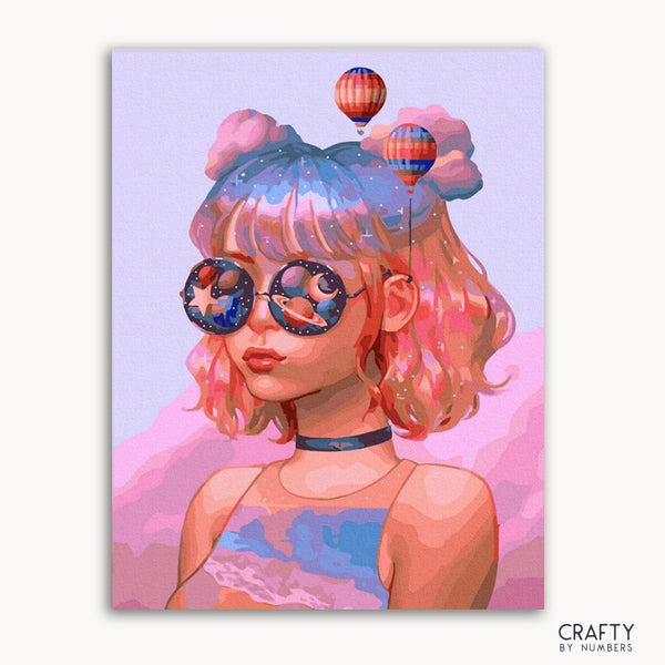 A vibrant painting of a stylized girl with pink hair and sunglasses, with a background featuring hot air balloons and a whimsical pattern. The artwork is framed.