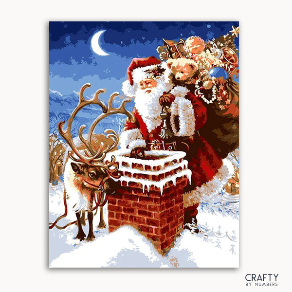 A paint-by-numbers kit depicting a Christmas scene with Santa Claus on a chimney, accompanied by a reindeer, against a moonlit background.