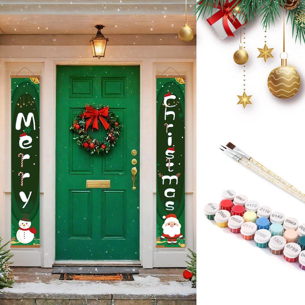 Decorative Christmas banners with festive designs on a green door, surrounded by Christmas decorations and paint supplies.