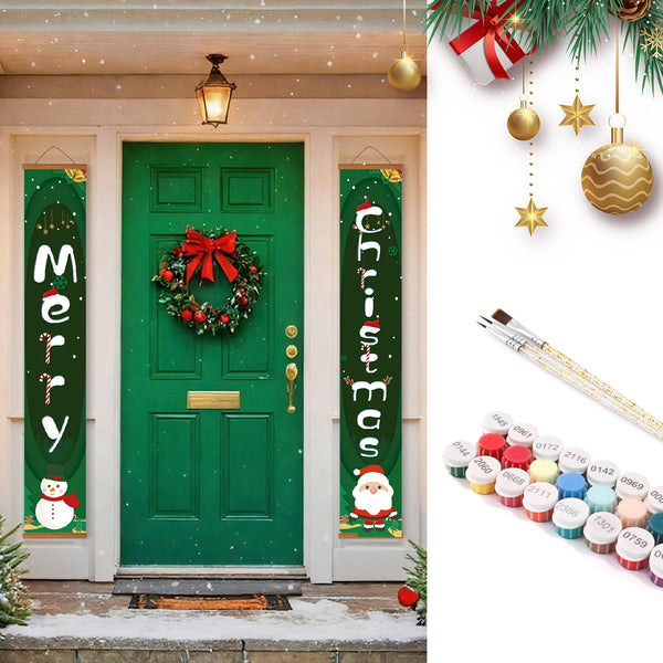 Decorative Christmas banners with festive designs on a green door, surrounded by Christmas decorations and paint supplies.