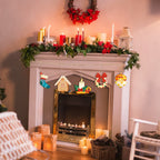 Decorated fireplace with Christmas mantel and decorations in a cozy living room.