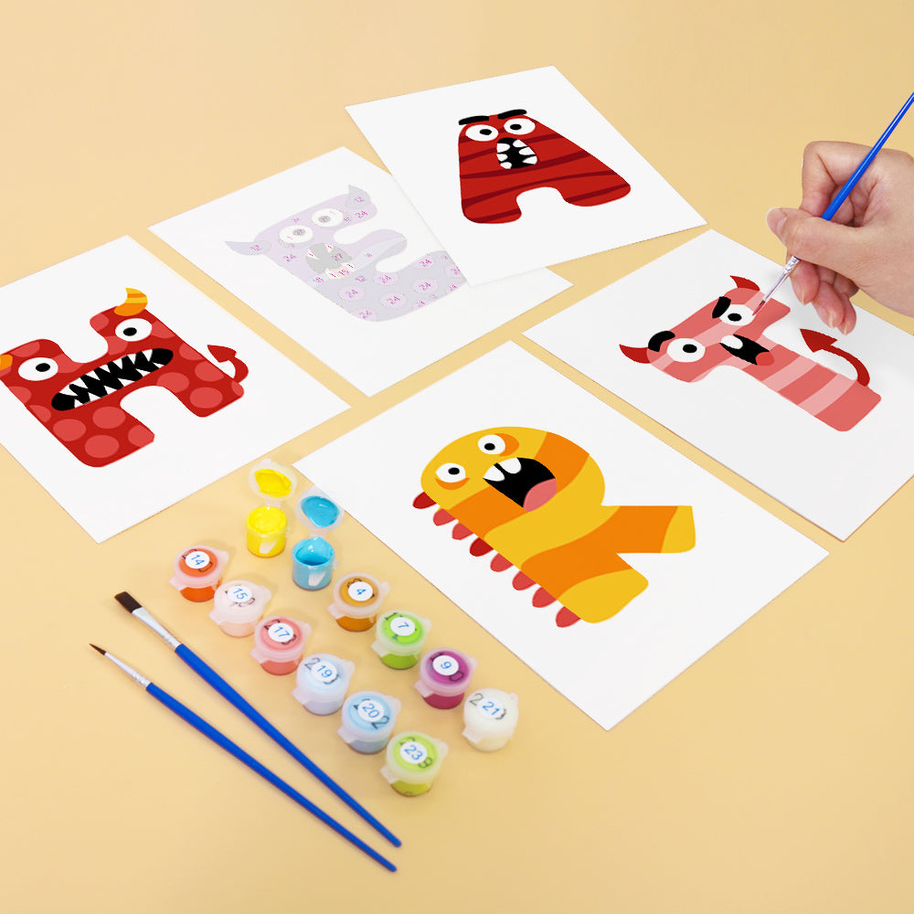 Children's art project with letter 'H' monsters and painting supplies on a beige background
