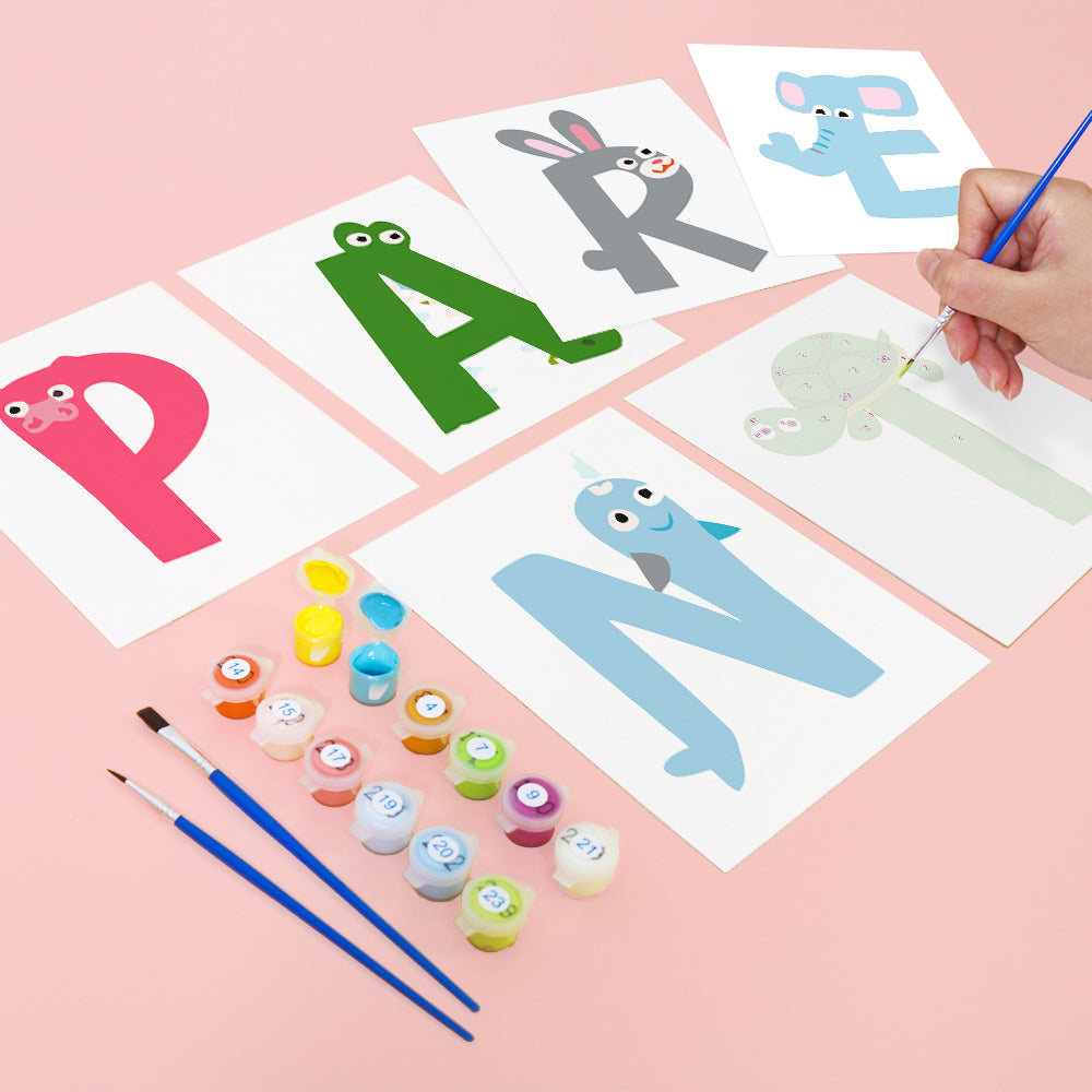 Children's painting activity with alphabet letters and paint supplies on a pink background