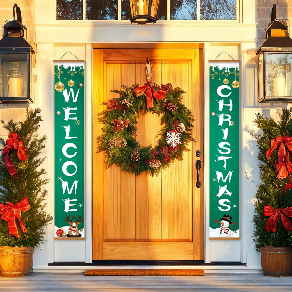 Puerta principal decorada con corona navideña y carteles festivos en el exterior de una casa.