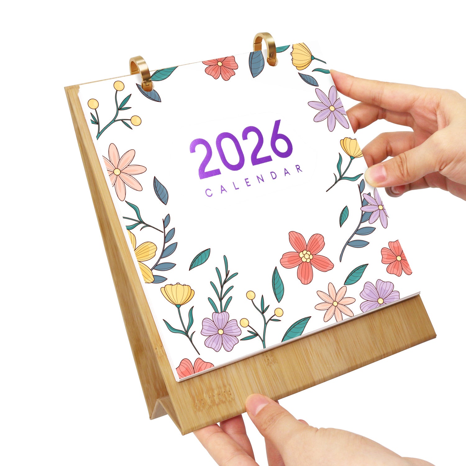 2026 calendar with floral design held by a hand on a white background