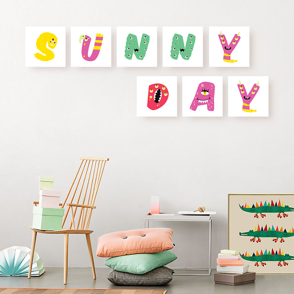 Colorful children's wall art with letters spelling 'SUNNY DAY' in a room setting.