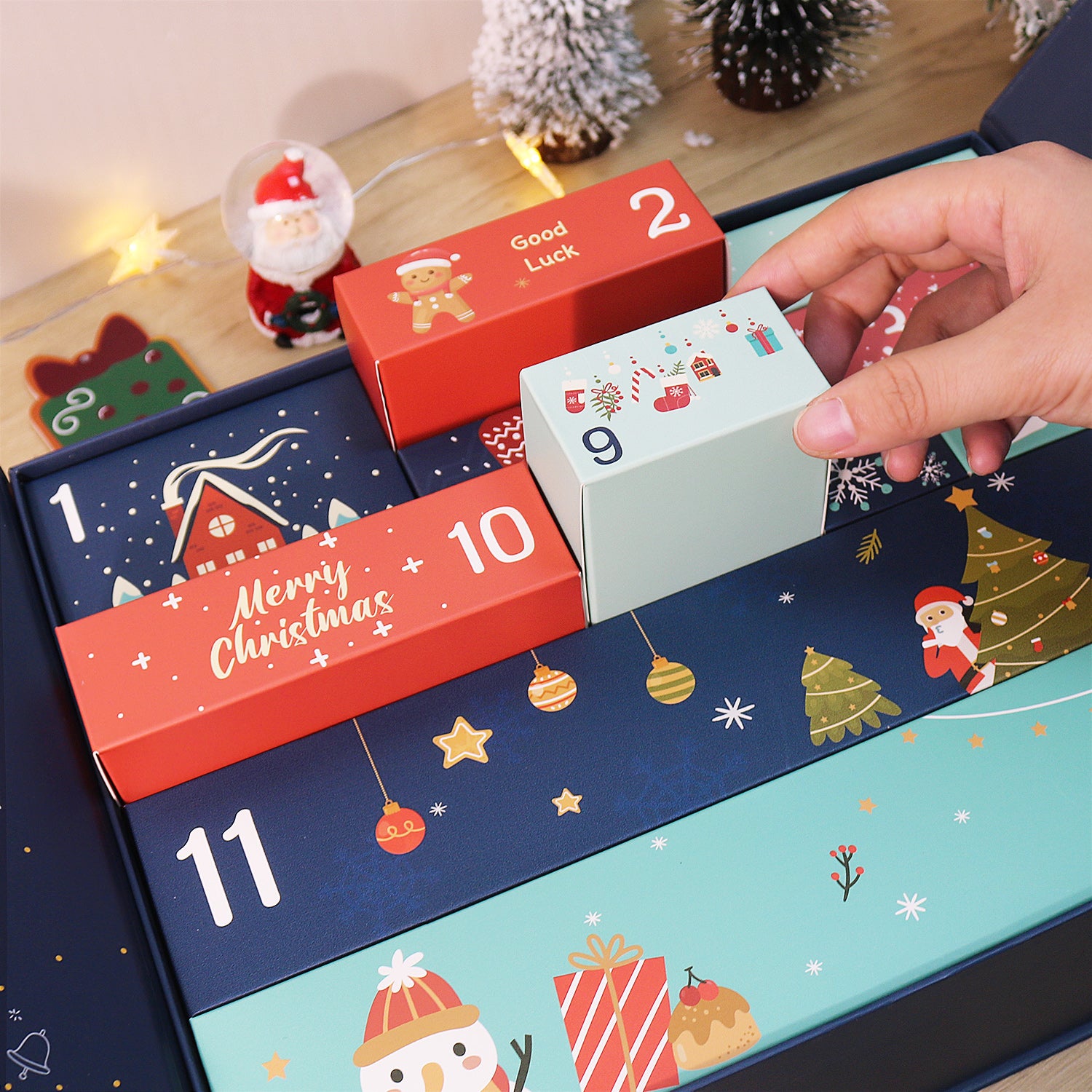 Christmas advent calendar with festive designs and a hand opening a door.