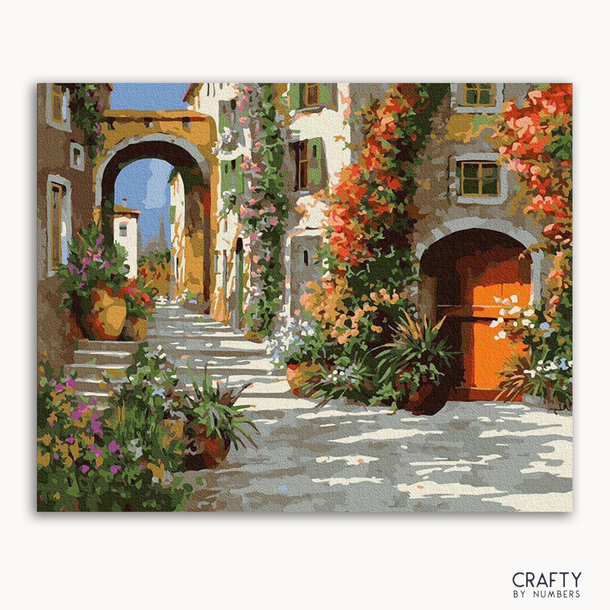 A vibrant painting depicting a narrow street with colorful flowers and old buildings, titled 'The Yard in Flowers' by Crafty by Numbers.