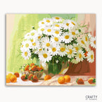 A painting kit representation of a bouquet of daisies with a green vase, white petals, and yellow centers, accompanied by oranges and twigs against a green background.