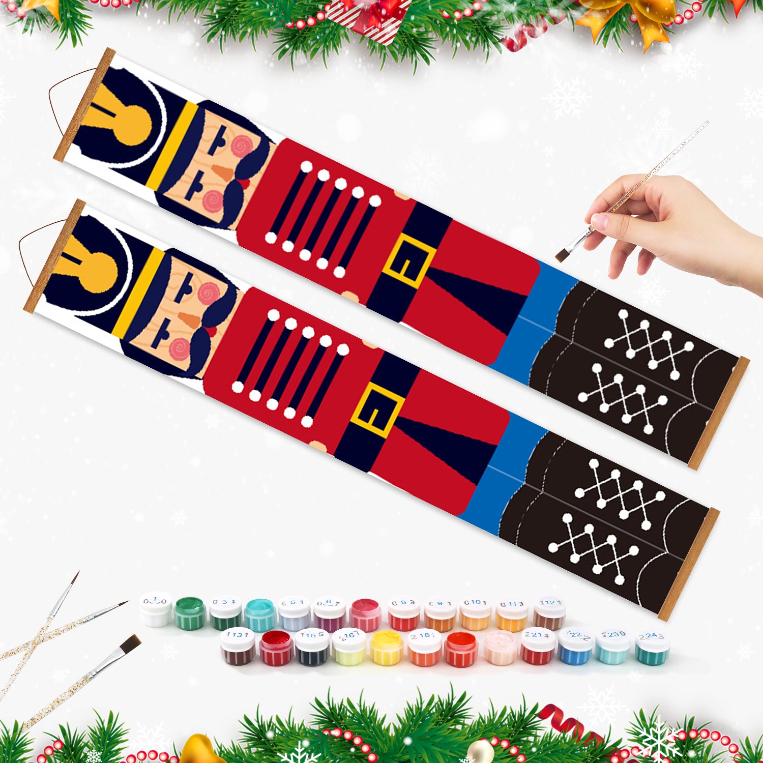 Colorful fabric painting kit with a hand holding a paintbrush, surrounded by Christmas decorations.