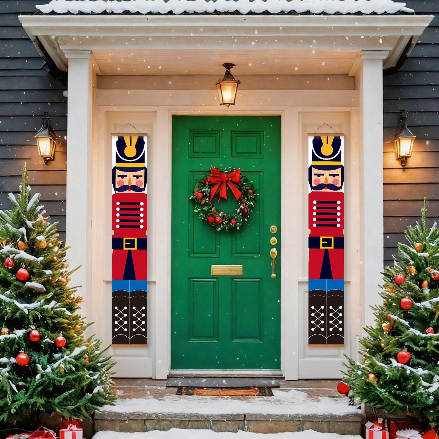 Green front door with Christmas wreath and decorations, flanked by two nutcracker banners and snow-covered trees.