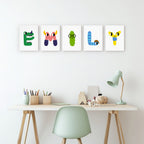 Colorful alphabet letter prints on a wall above a desk with stationery.