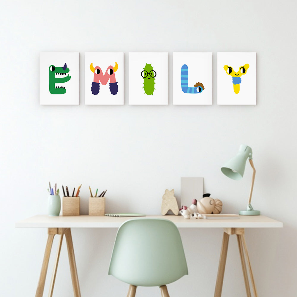 Colorful alphabet letter prints on a wall above a desk with stationery.