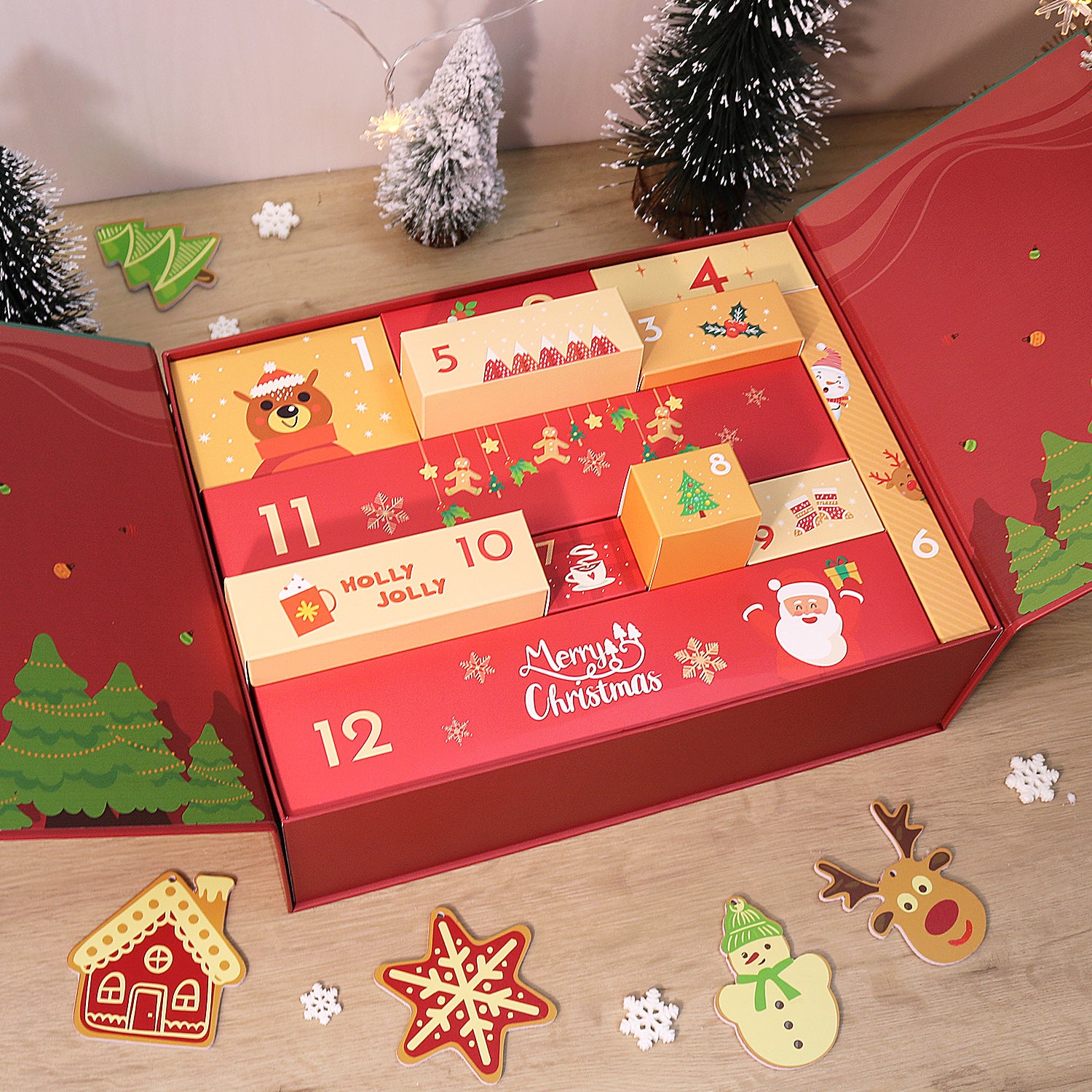 Red advent calendar with Christmas-themed compartments on a wooden surface.