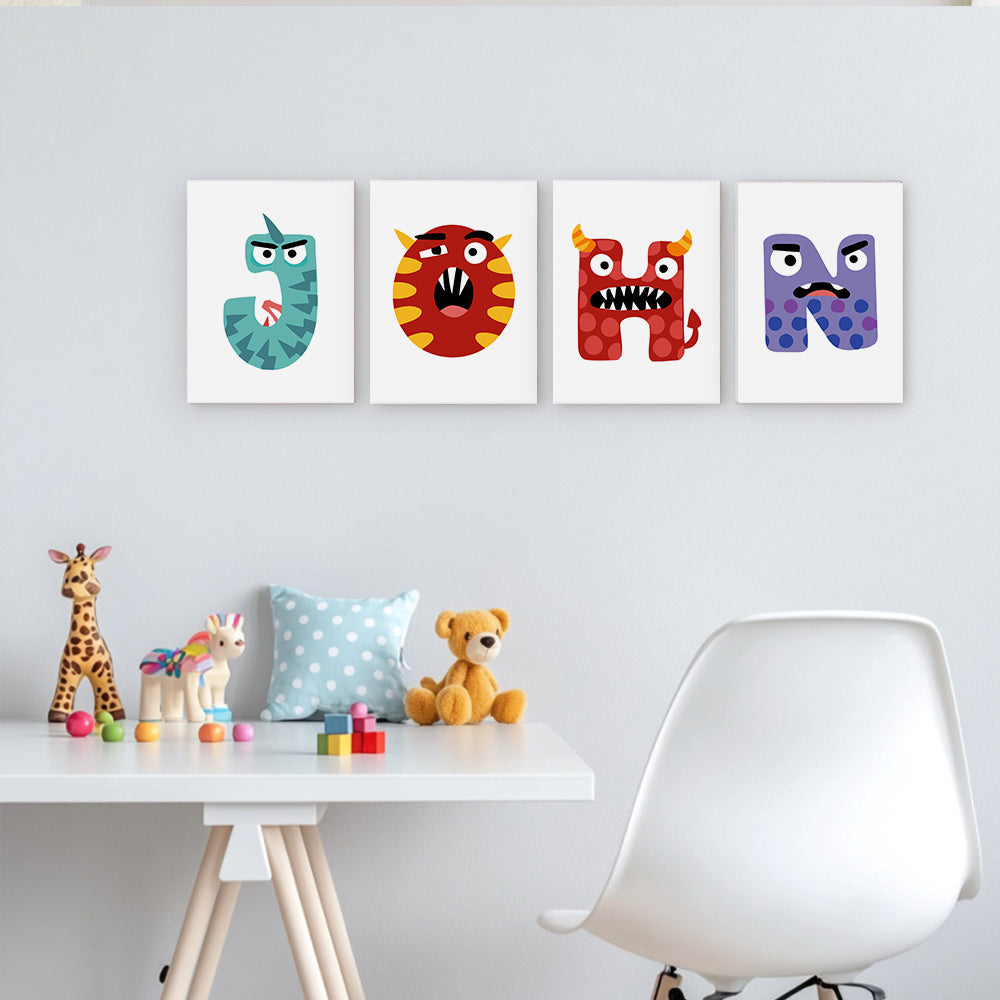 Four colorful children's posters with letters on a wall above a white table with toys.