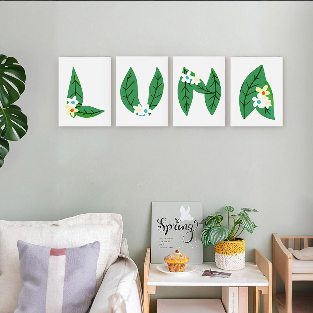 Four leaf-themed wall art pieces on a gray wall above a white sofa.