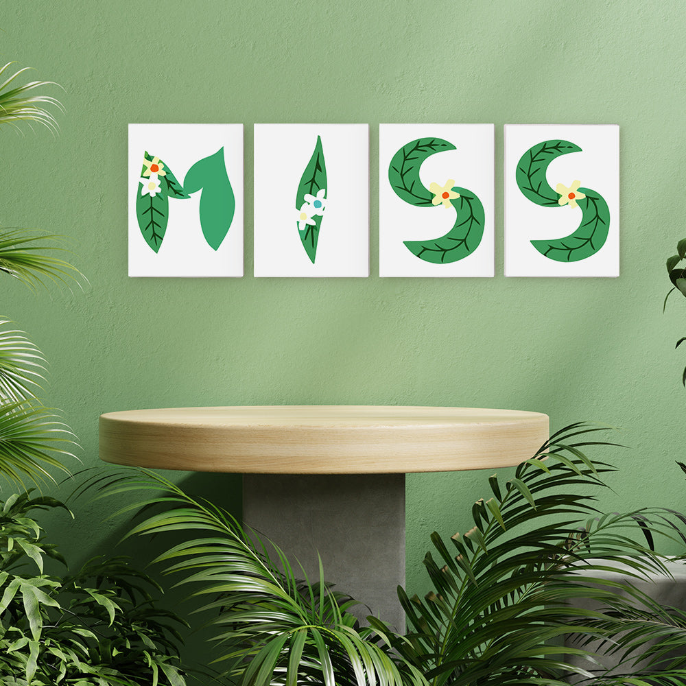 Four leaf-shaped prints spelling 'MISS' on a green wall with a wooden table and plants.