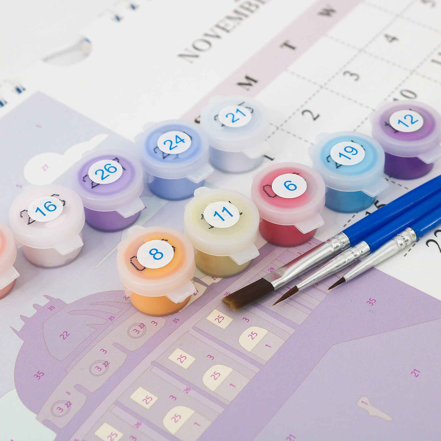 Set of small round containers with numbers on a planner background