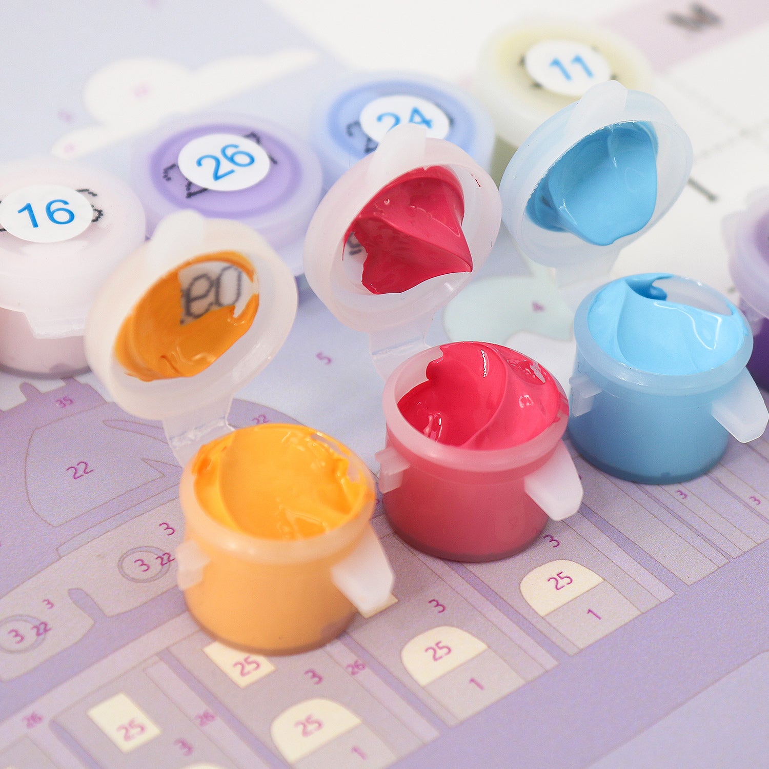 Colorful calendar with numbered compartments and small containers on a light purple background