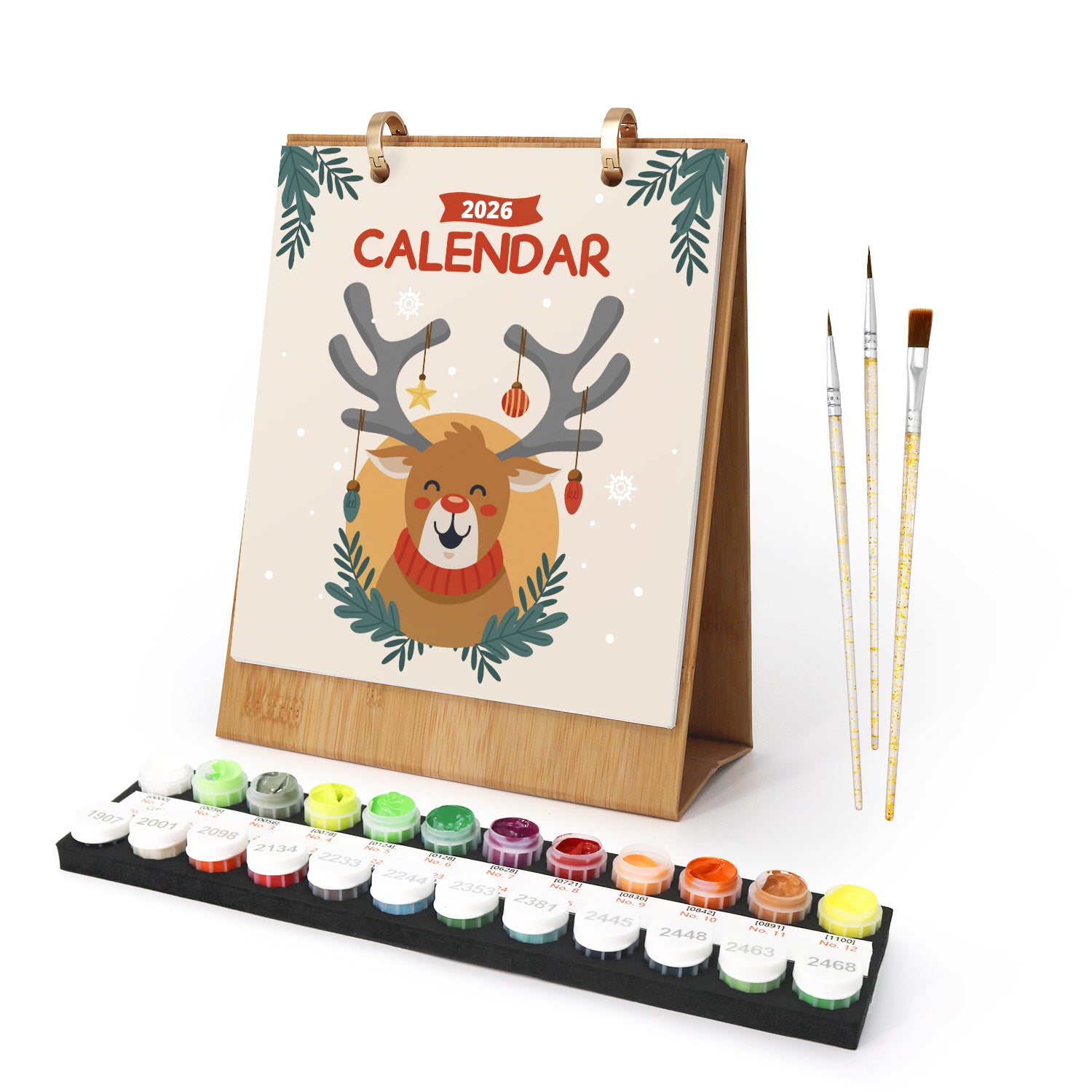 Calendario con diseño de renos, juego de pintura y pinceles sobre fondo blanco.